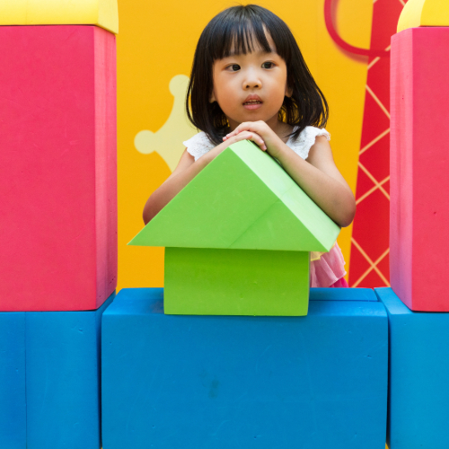 Kid playing with giant blocks